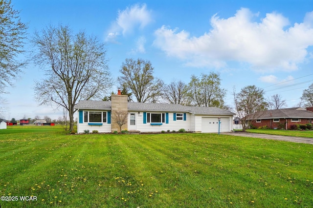 ranch-style home featuring a chimney, aphalt driveway, a front yard, and an attached garage