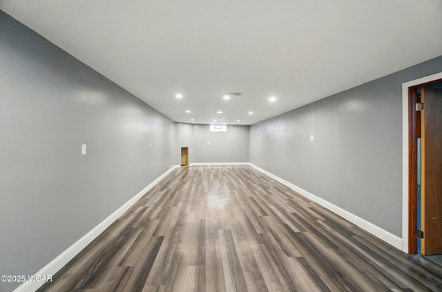 finished basement with baseboards, recessed lighting, and wood finished floors