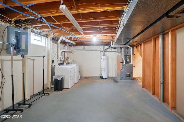 below grade area with water heater, heating unit, separate washer and dryer, and electric panel
