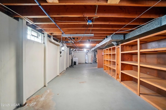 basement with heating unit, water heater, and independent washer and dryer