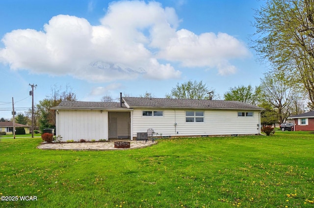 back of property with cooling unit, an outdoor fire pit, a yard, and a patio