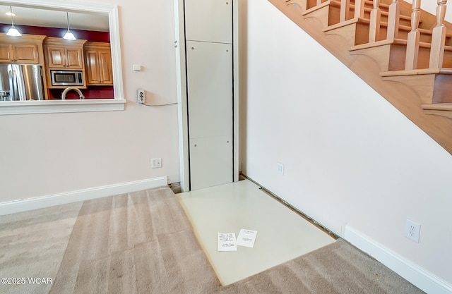 interior space with stairs and baseboards