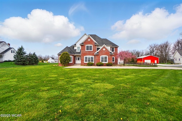 view of front facade featuring a front yard and brick siding