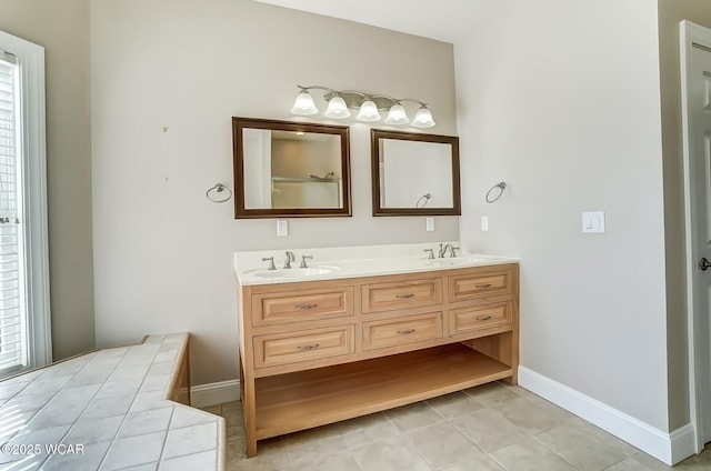 bathroom featuring a sink, baseboards, and double vanity