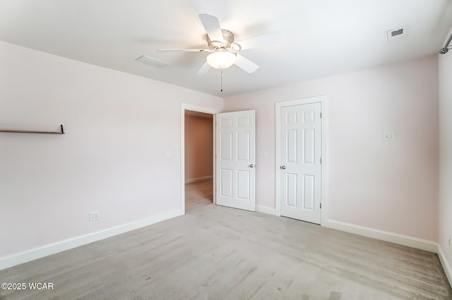 unfurnished bedroom with a closet, visible vents, a ceiling fan, light carpet, and baseboards