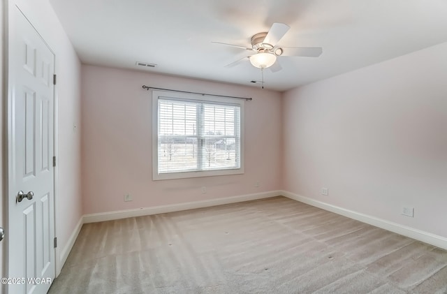 unfurnished room featuring ceiling fan, visible vents, and baseboards