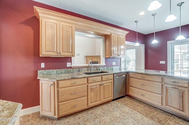 kitchen with dishwasher, light brown cabinetry, a sink, and decorative light fixtures