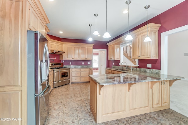 kitchen featuring a peninsula, a kitchen bar, stainless steel appliances, under cabinet range hood, and light brown cabinets