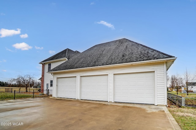 detached garage featuring fence