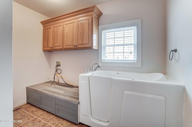 laundry area with hookup for a washing machine and cabinet space