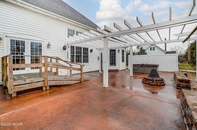 view of patio / terrace with french doors, a hot tub, and a pergola