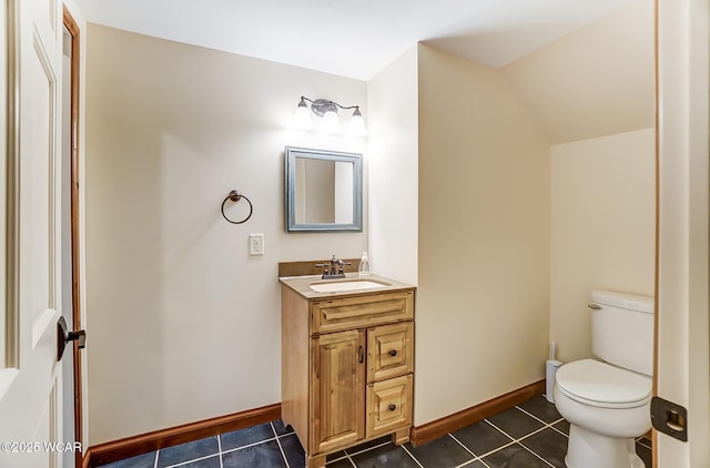 half bathroom featuring tile patterned flooring, baseboards, lofted ceiling, and toilet