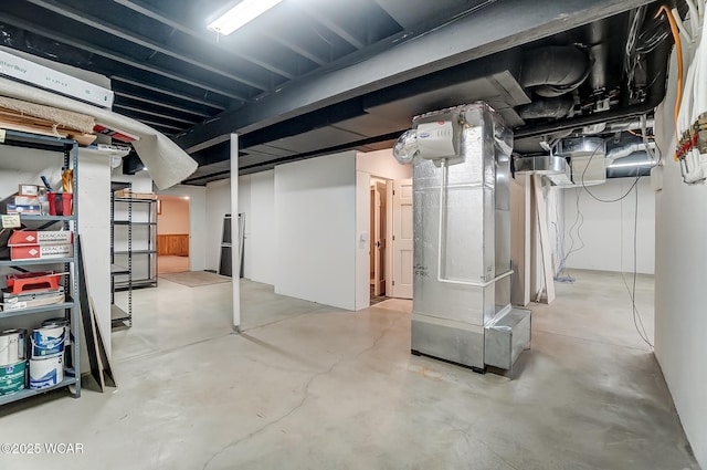 unfinished basement featuring heating unit