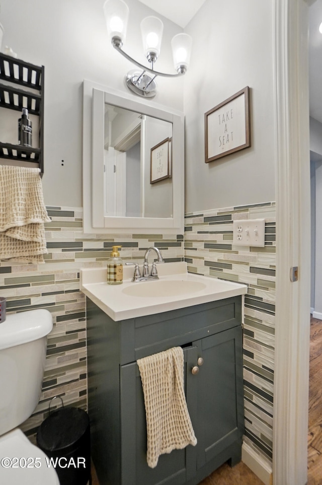 1826 W High St, Lima, OH 45805 - bathroom with tile walls, vanity, toilet, and a wainscoted wall