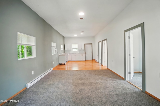 1151 S Central Ave, Lima, OH 45804 - unfurnished living room featuring baseboard heating, light colored carpet, and recessed lighting
