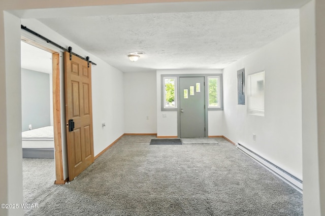 1151 S Central Ave, Lima, OH 45804 - carpeted entrance foyer with a baseboard radiator, a barn door, and a textured ceiling