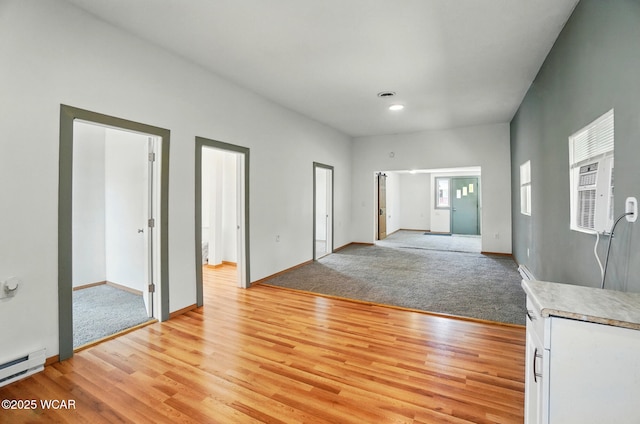 1151 S Central Ave, Lima, OH 45804 - empty room with light wood-type flooring, light carpet, a baseboard heating unit, and recessed lighting