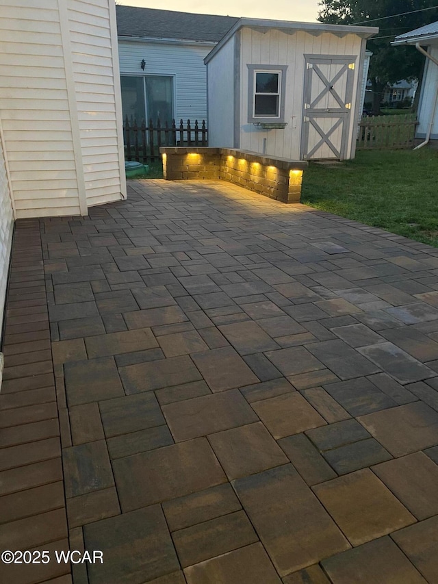 view of patio featuring a shed