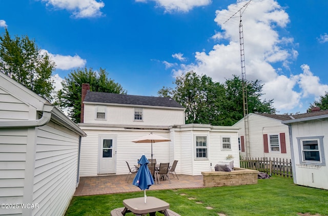 back of house with a lawn and a patio area