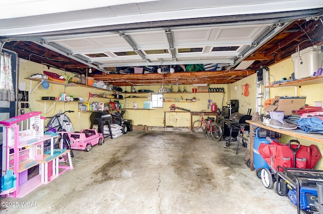 garage featuring a garage door opener and a workshop area