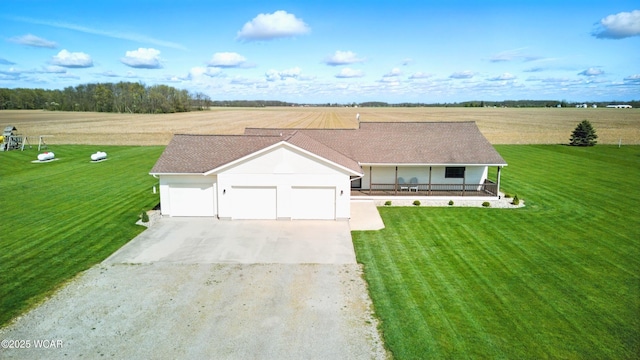 ranch-style home with an attached garage, a front lawn, covered porch, and concrete driveway