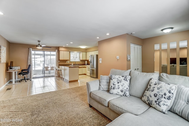 living room featuring ceiling fan and light tile patterned floors