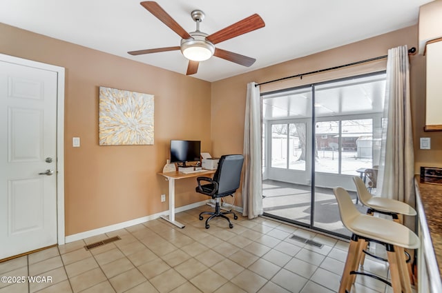 office area with ceiling fan and light tile patterned floors