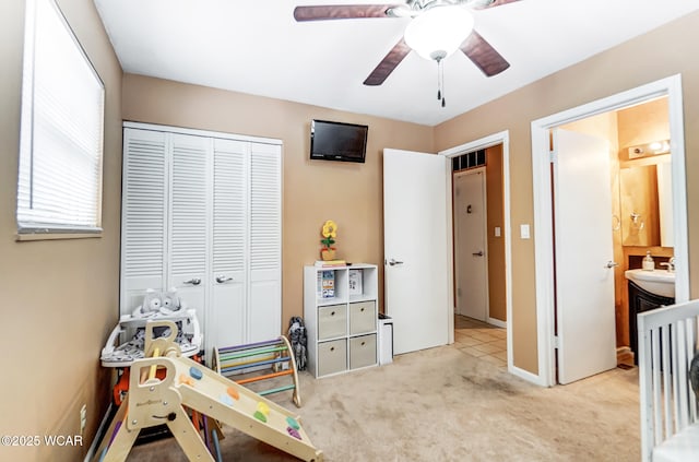 game room featuring light carpet, ceiling fan, and sink