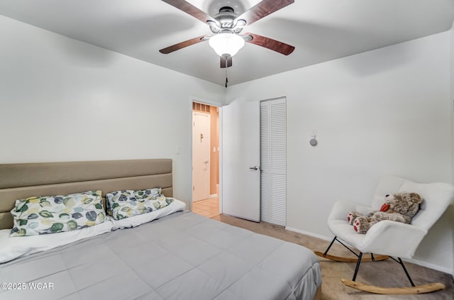 carpeted bedroom featuring a closet and ceiling fan