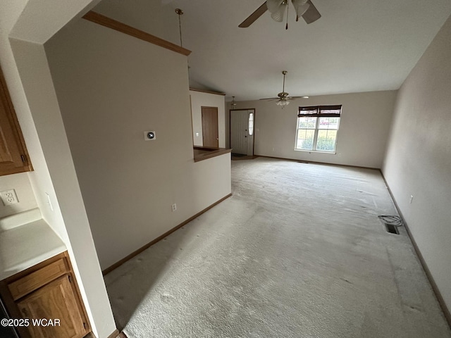 unfurnished living room featuring light colored carpet and ceiling fan