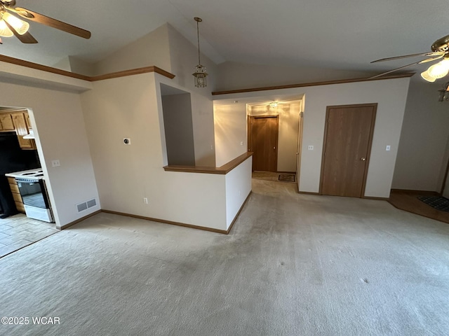 unfurnished living room featuring vaulted ceiling, light colored carpet, and ceiling fan