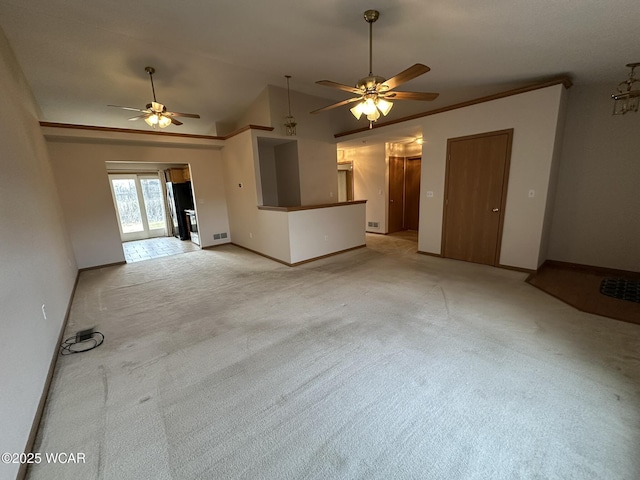 unfurnished living room featuring vaulted ceiling, ornamental molding, light carpet, and ceiling fan