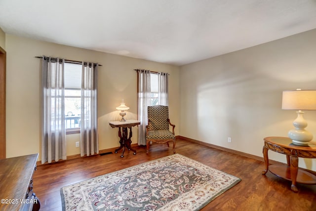 sitting room featuring a healthy amount of sunlight and dark wood-type flooring