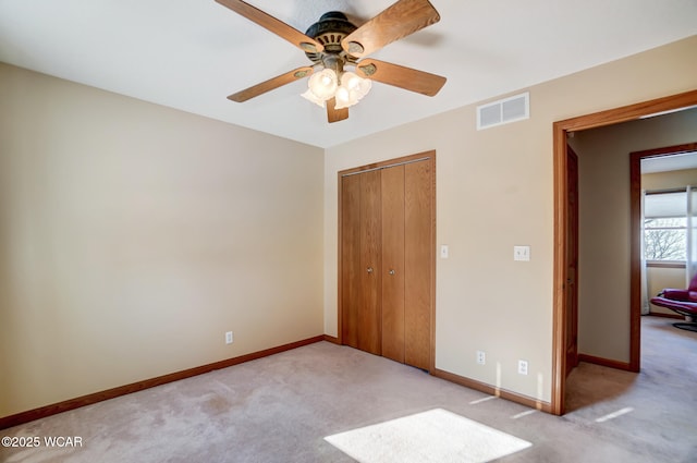 unfurnished bedroom with light carpet, a closet, and ceiling fan