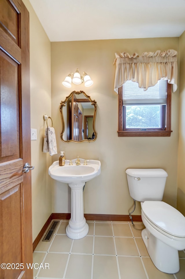 bathroom with tile patterned flooring and toilet