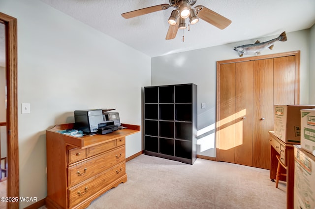 bedroom featuring light colored carpet and a textured ceiling