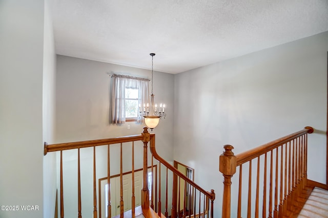 staircase featuring an inviting chandelier