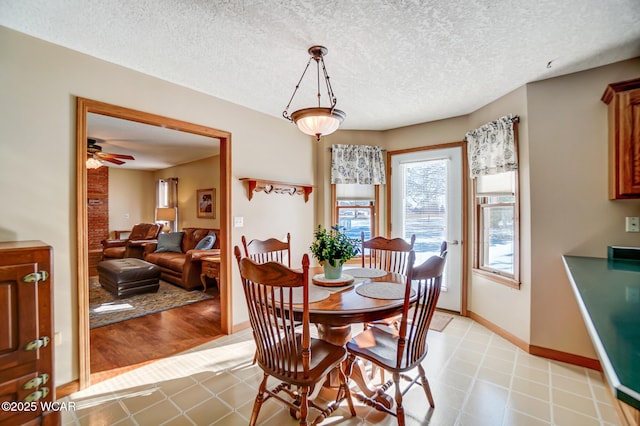 dining space featuring a textured ceiling