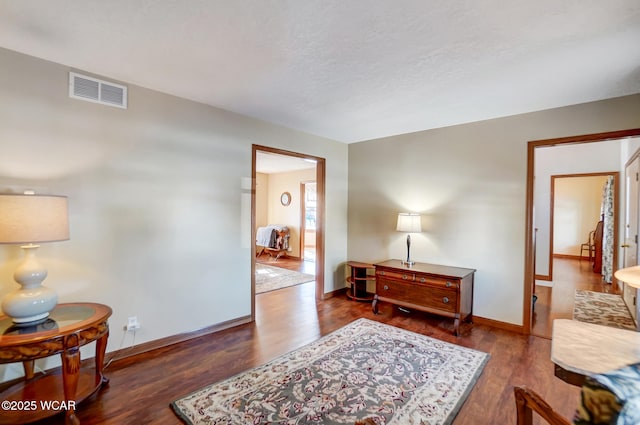 sitting room with dark hardwood / wood-style flooring