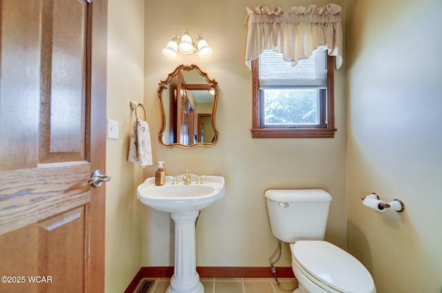 bathroom featuring tile patterned flooring and toilet