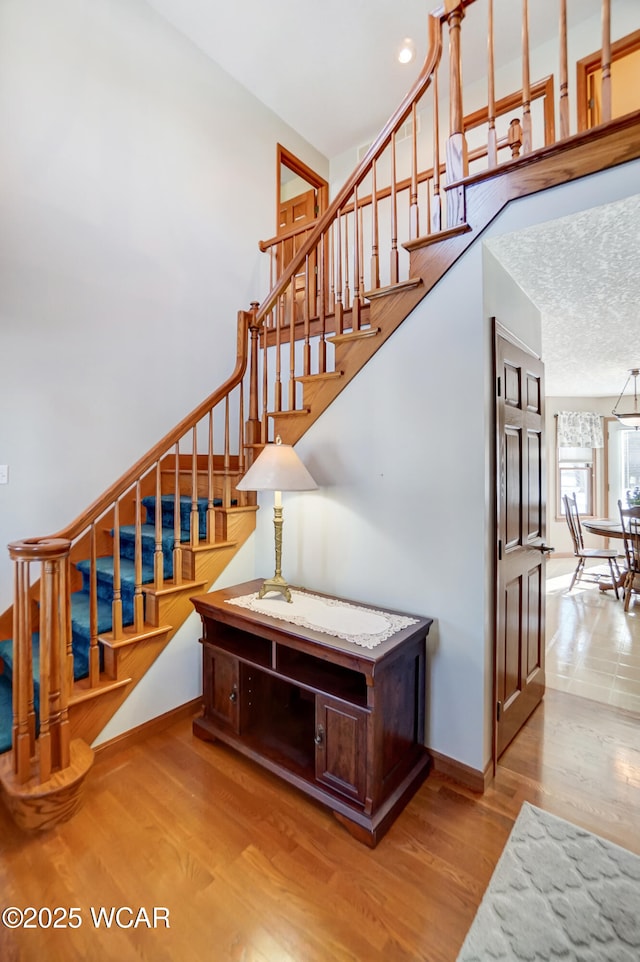 staircase with hardwood / wood-style flooring