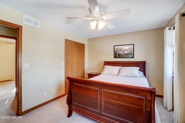 carpeted bedroom with ceiling fan and a closet