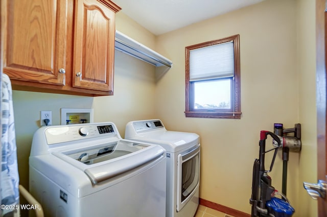 washroom with cabinets, light tile patterned flooring, and washer and dryer