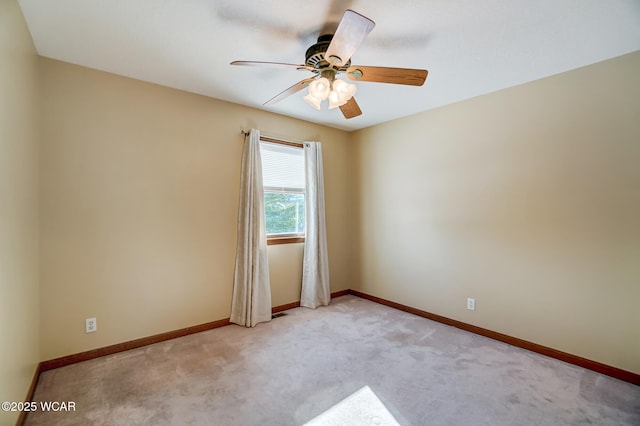 empty room featuring light carpet and ceiling fan