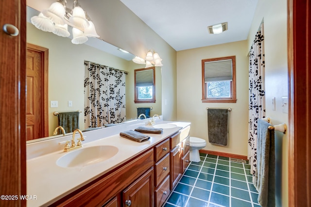 bathroom with tile patterned flooring, vanity, and toilet