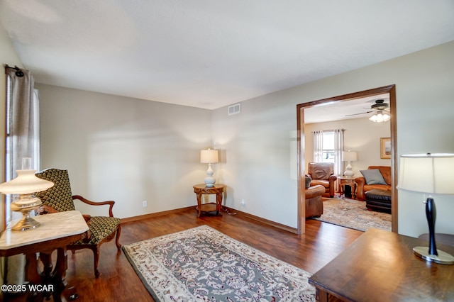 sitting room featuring dark wood-type flooring