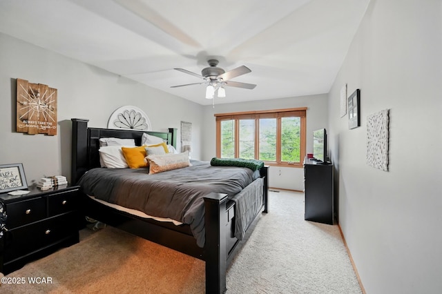 bedroom featuring light carpet, baseboards, and ceiling fan