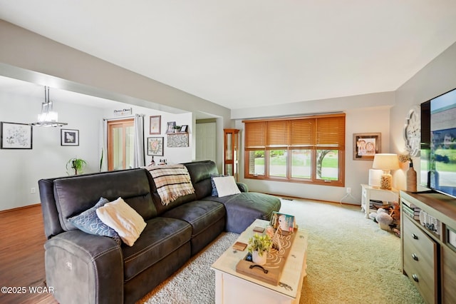 living room featuring an inviting chandelier and baseboards
