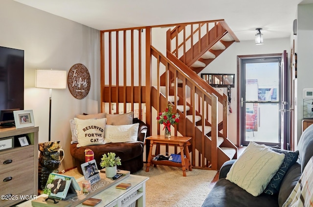 carpeted living room featuring stairway