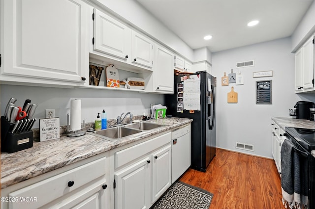 kitchen with a sink, electric range, visible vents, and dishwasher